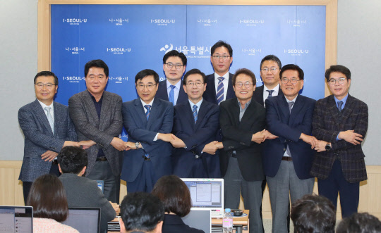 박원순 서울시장(가운데), 조희연 서울시교육감(오른쪽 세번째)과 참여 구청장들이 29일 서울시청에서 고교 등 친환경 무상급식 확대 정책에 대해 발표한 뒤 함께 손을 맞잡고 있다. 연합뉴스